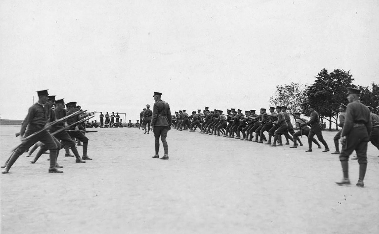 A group of men in uniform in two lines with rifles