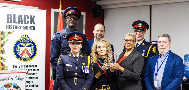 Group of people standing together with an award