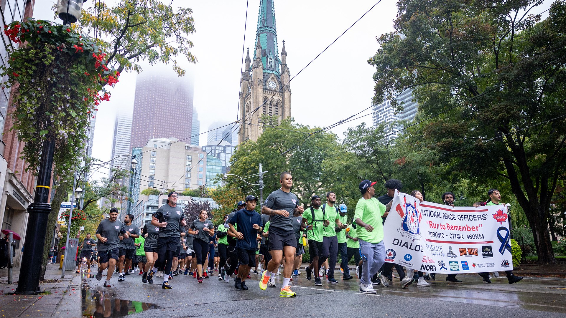 Runners make their way past St. James Cathedral in the first leg of their 460-km relay to Ottawa.