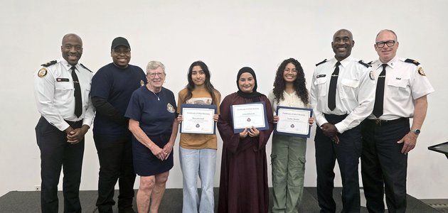 Group of people, some hold certificates