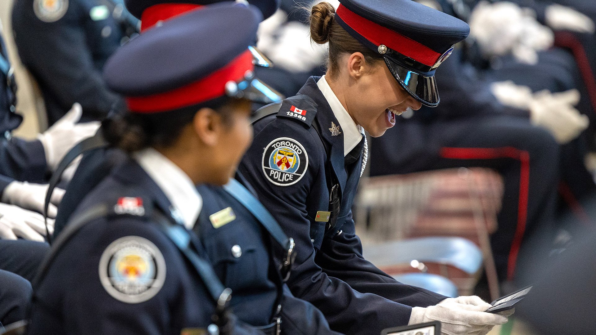 Police officers looking at their warrant cards.