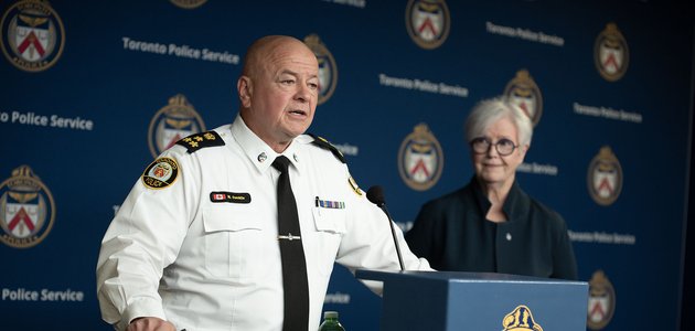 Police officer at podium with another person