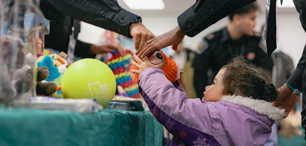 Child being handed a toy