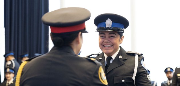 Parking officer smiling at police officer