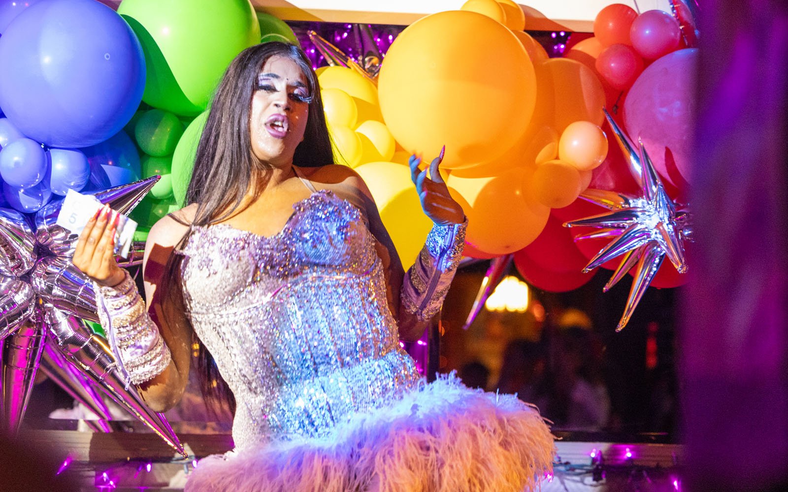 person dancing surrounded by many colourful baloons