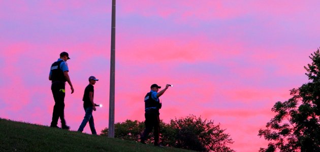 Three silohouettes against a sunset