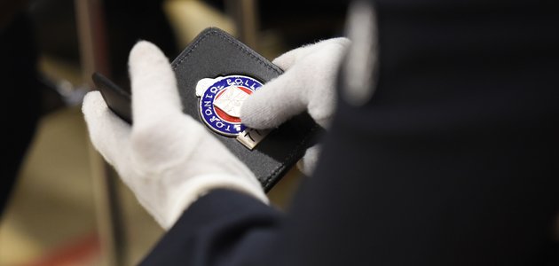 Police Officer holding badge