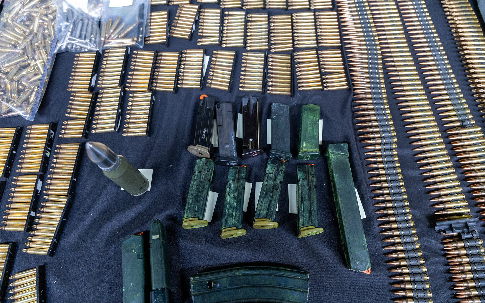 Firearm magazines and ammunition on a table.