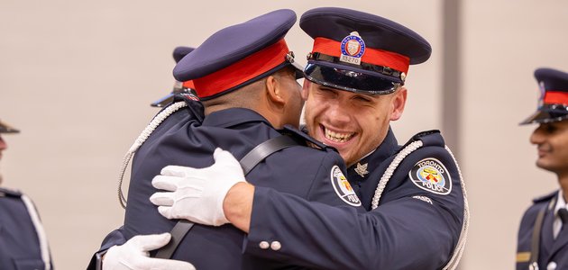 Two police officers hugging