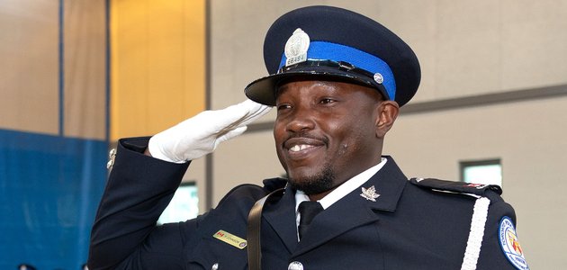 Person in uniform saluting.