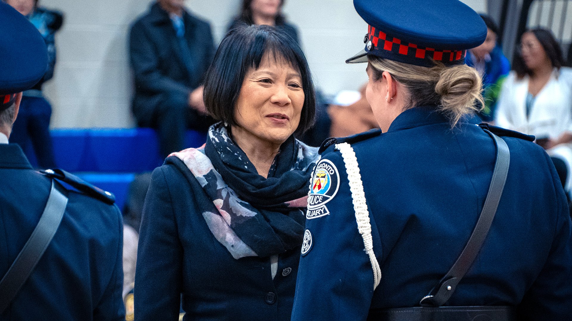 Person speaking with an auxiliary officer.