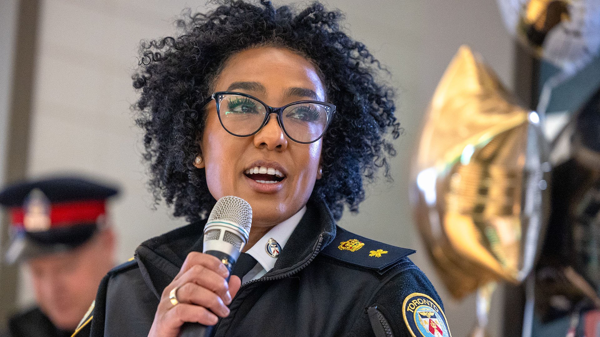 Police officer speaking into microphone
