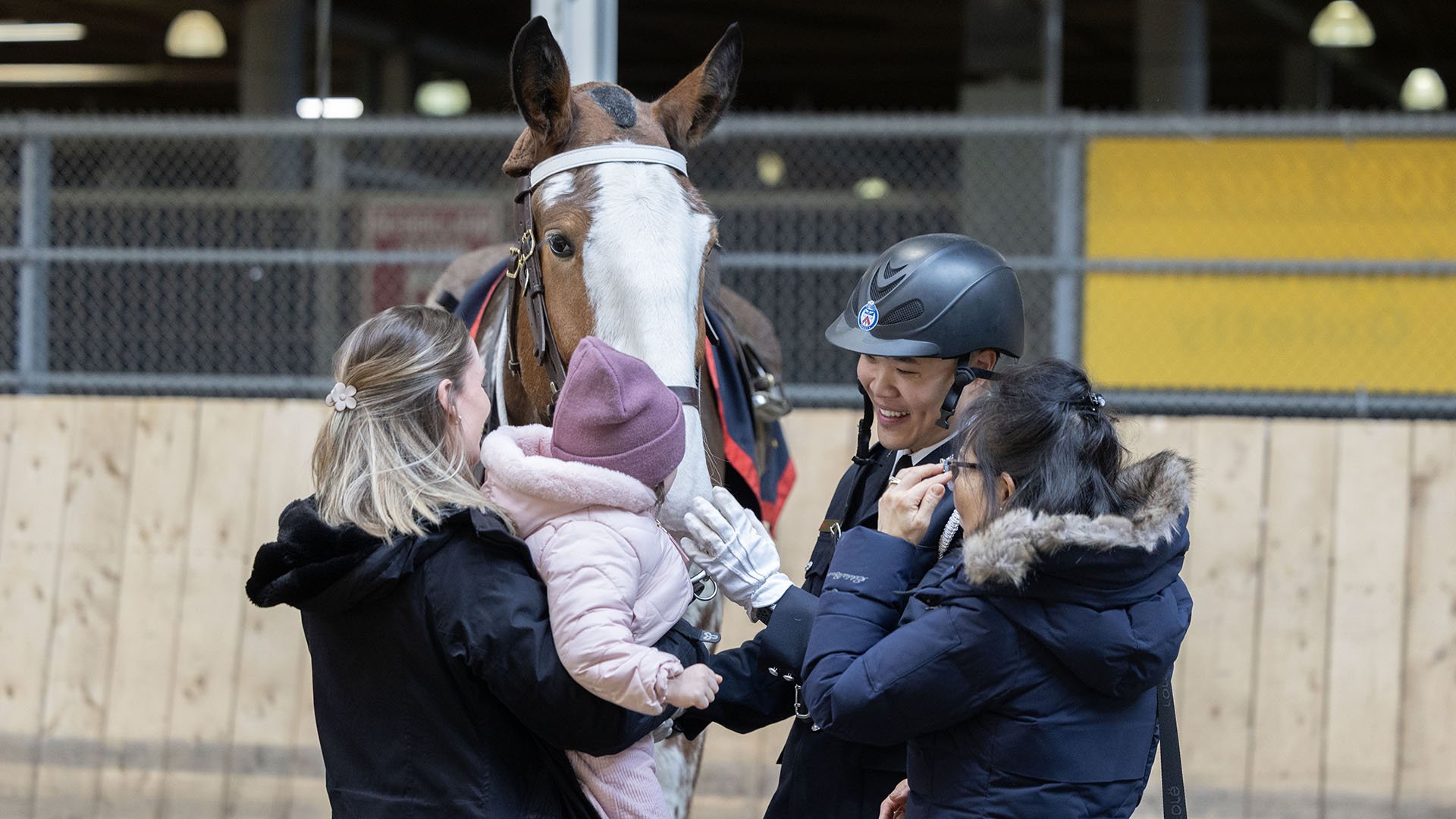 Police officer with people and horse