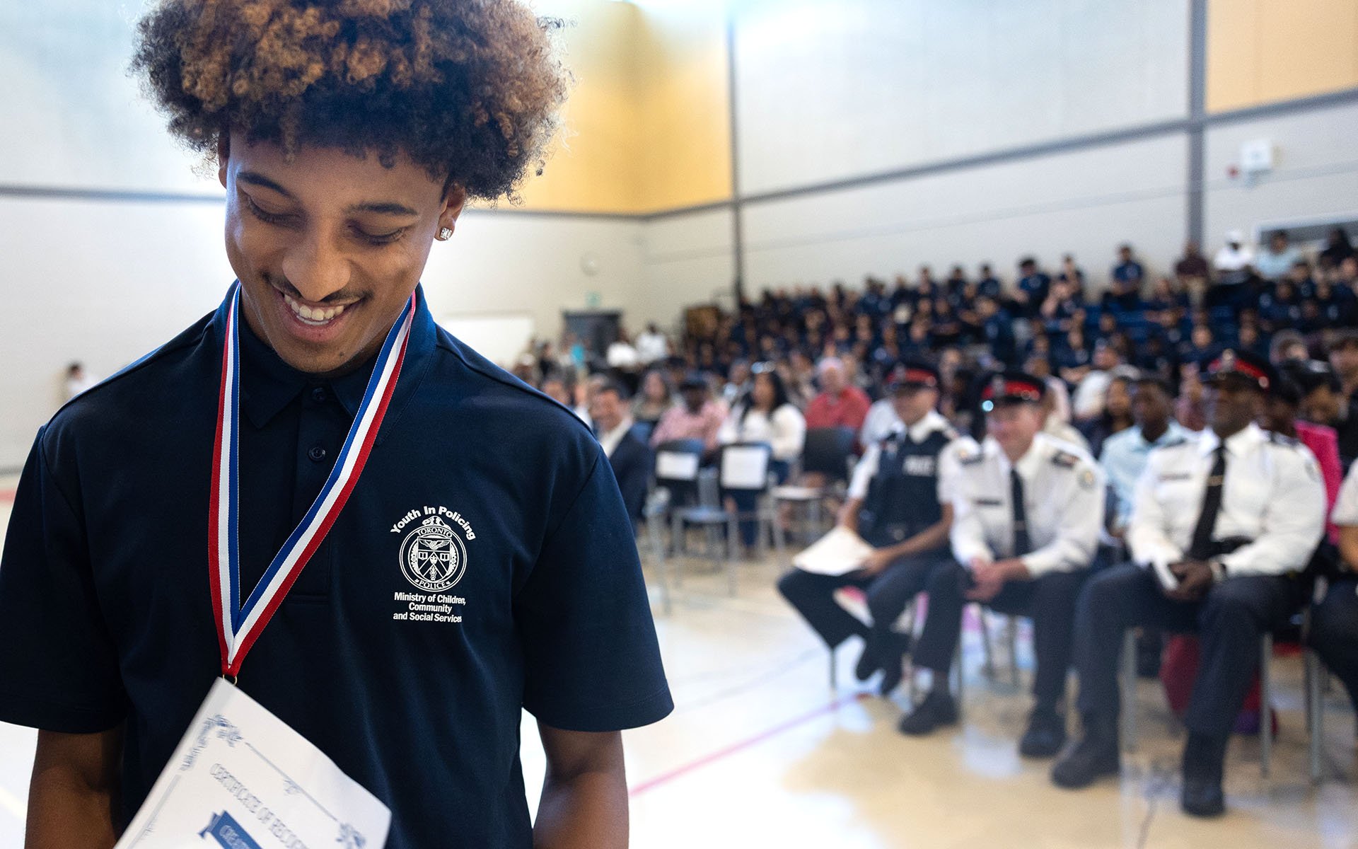 Person smiling in front of an audience