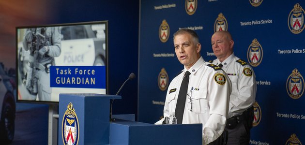 Police officers at a podium
