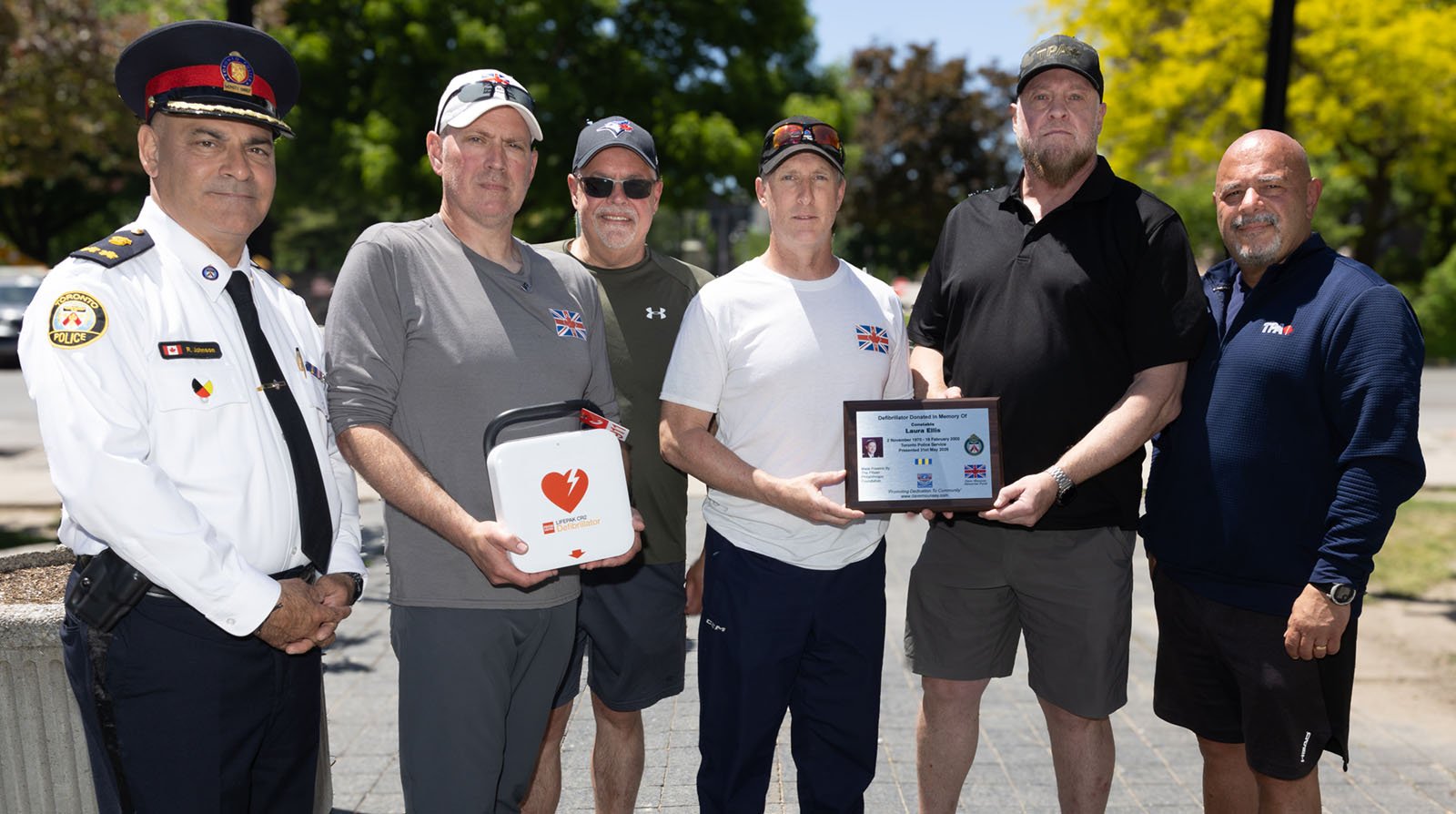 group of men some holding plaques are standing outdoors