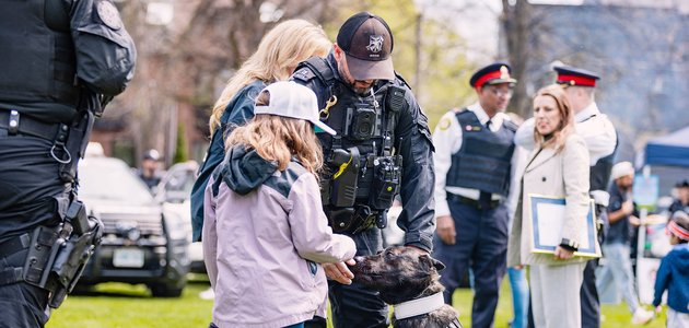 Police officer with dog and child