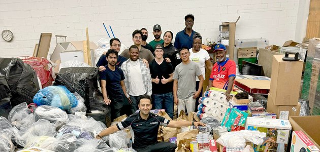 People in a room of boxes and bags