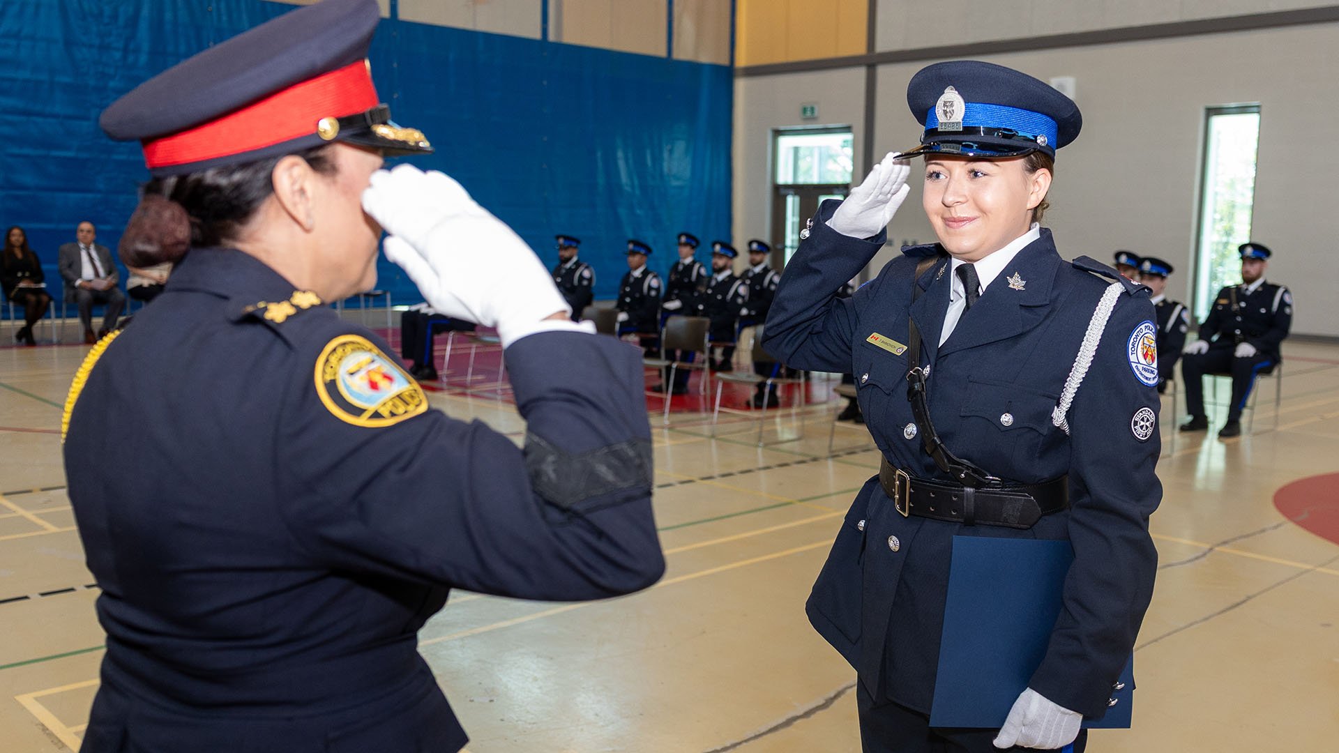Two people in uniform saltue