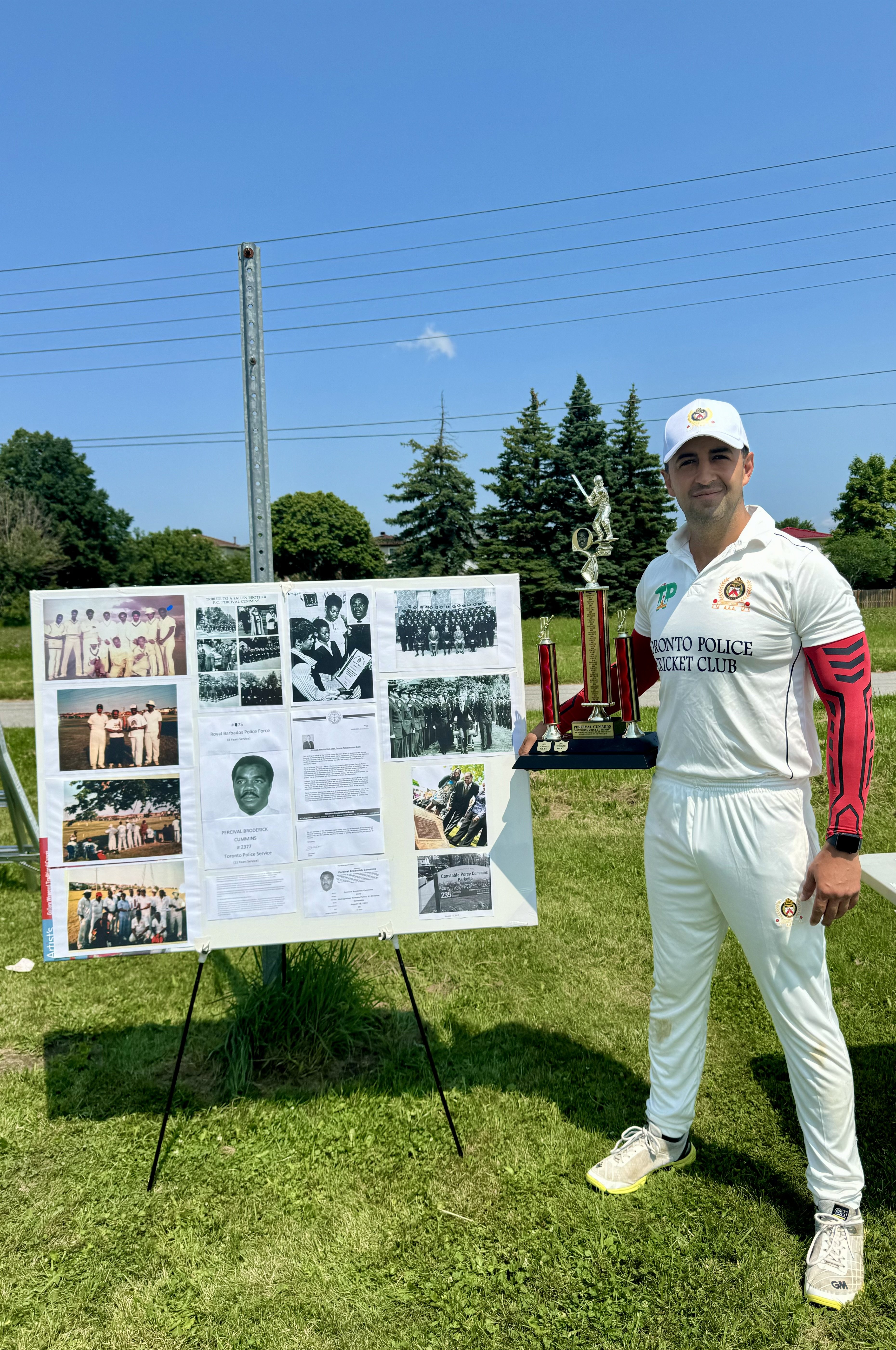 Cricket player stands with his trophy