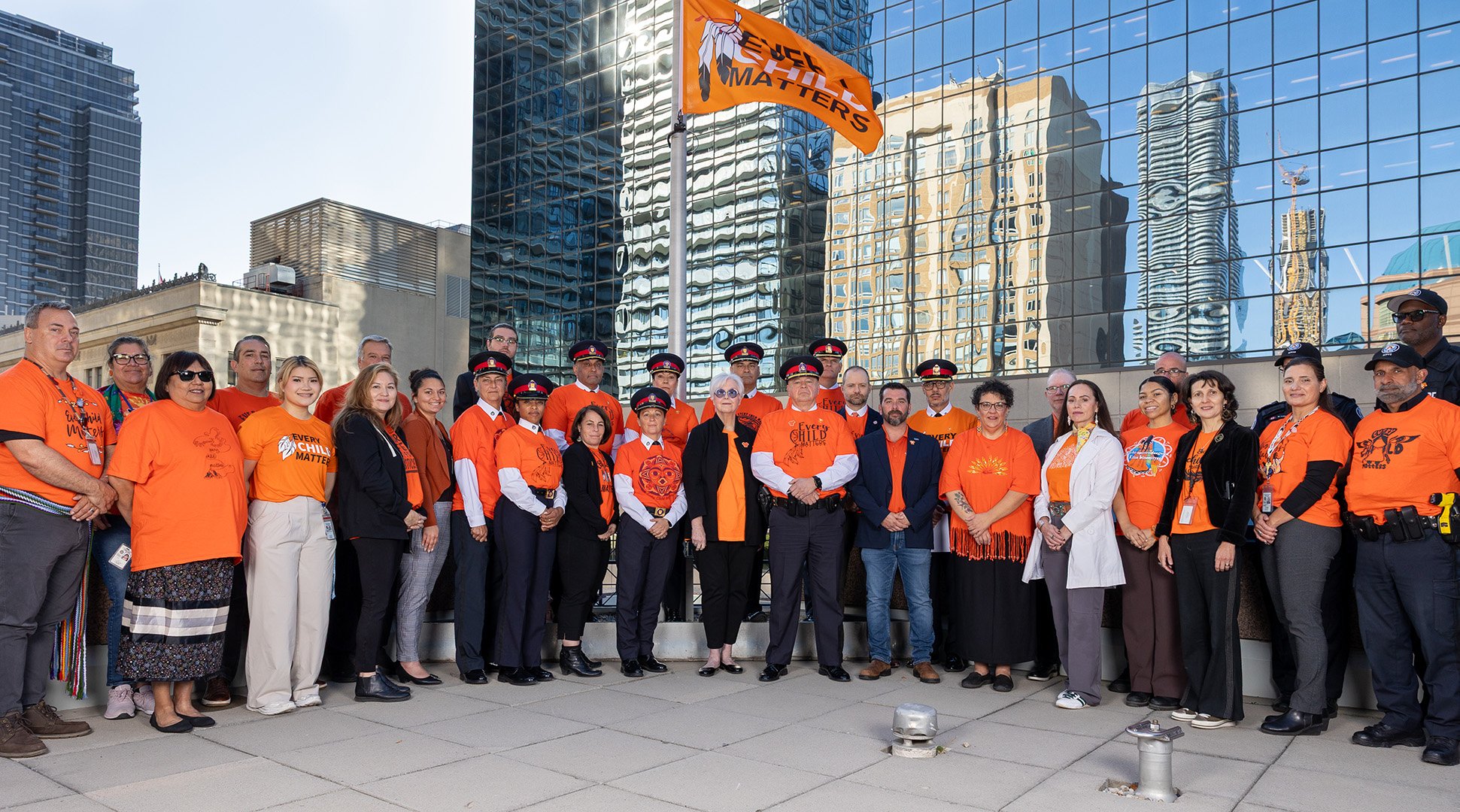 Group of people in orange shirts