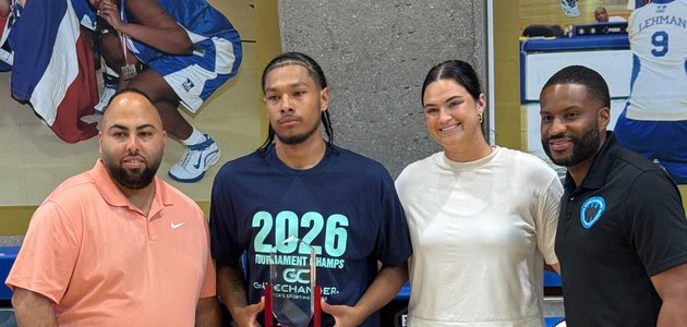 three man and one woman pose for a photo; a man in the middle is holding an award