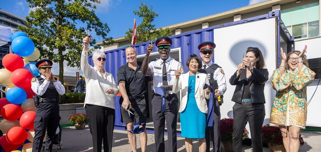 Group of people cutting a ribbon