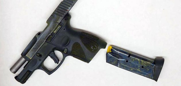 photo of a handgun with an ammo magazine next to it