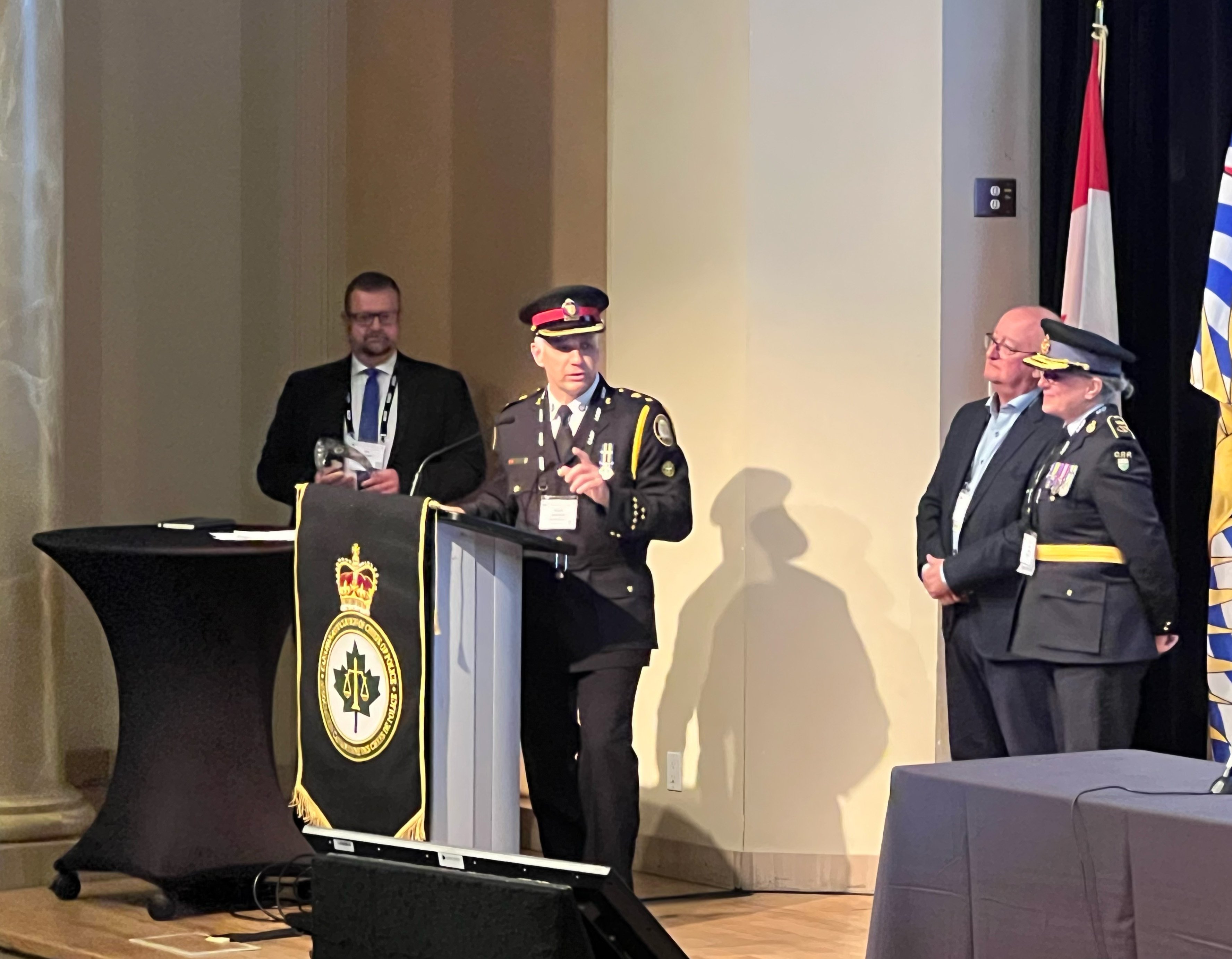 A police officer standing at a podium on stage