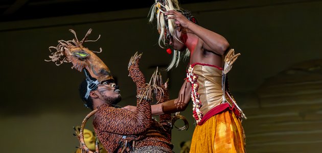Two people in costume on stage
