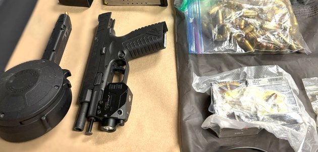 Handgun, magazine and ammunition on a table