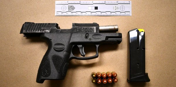 Black handgun, bullets and a magazine