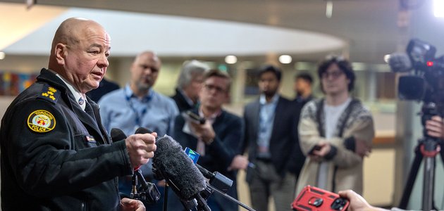 Police officer speaks to media