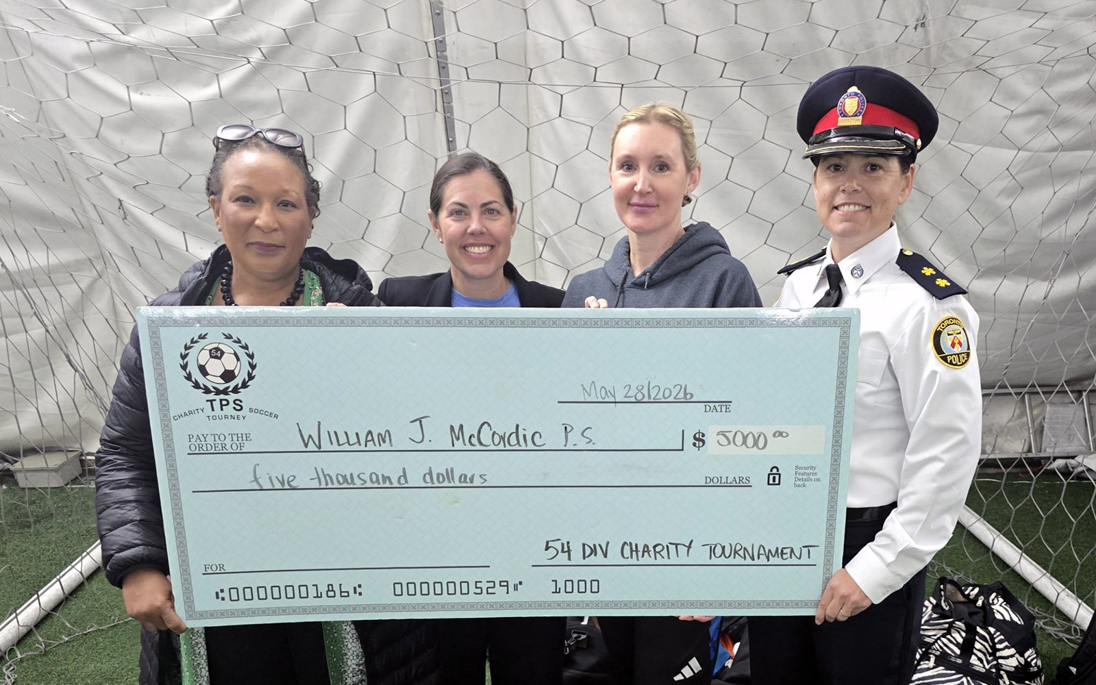 group of women holding a large cheque