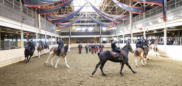 Police officers on horseback with pipers and drummers