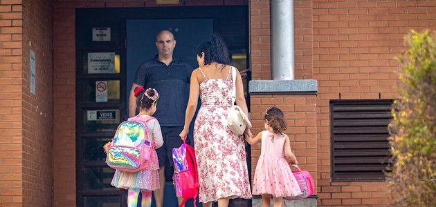 Adults and children at school door