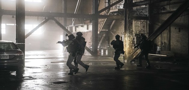 Police officers walking through an abandoned building