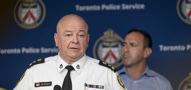 Police officers speaking at a podium