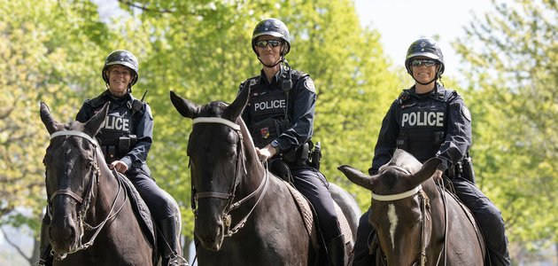 three police officers on horses