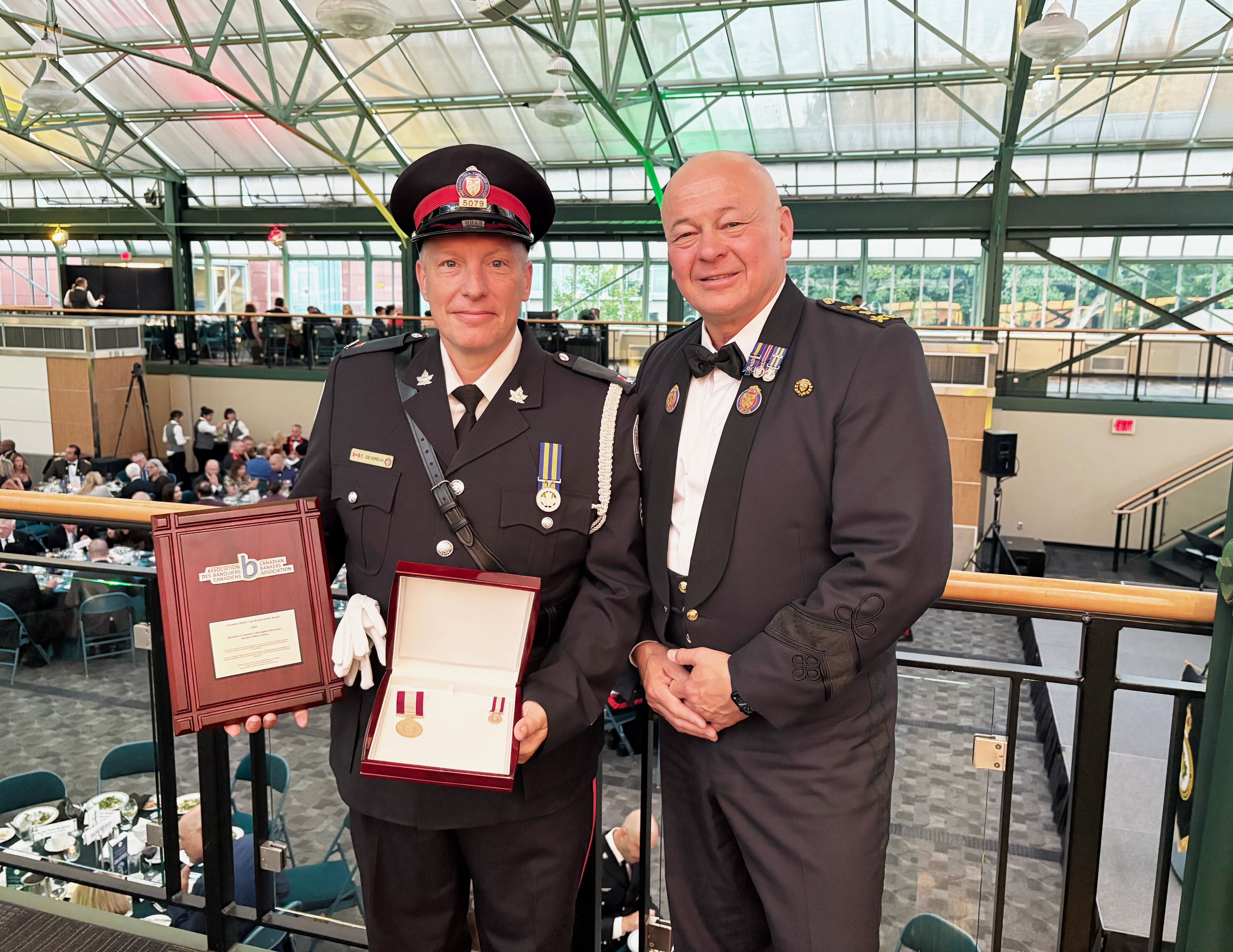 A police officer standing side-by-side with a man