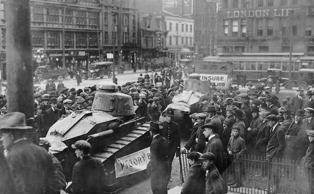 A group of people around a tank