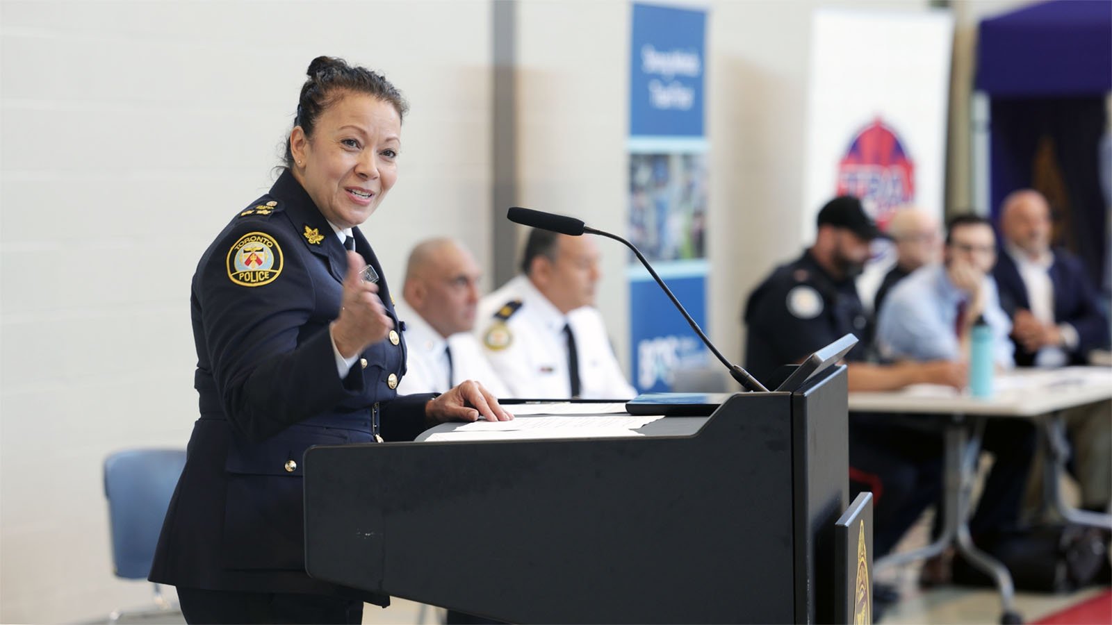 Deputy Chief Lauren Pogue at podium at the College