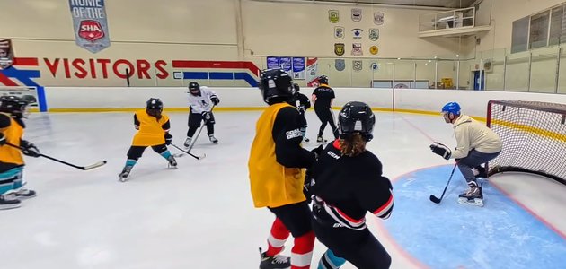 group of students and adjults playing hockey