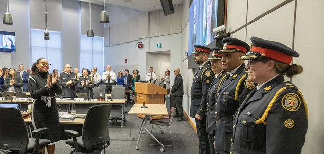 Group of police officers receiving standing ovation
