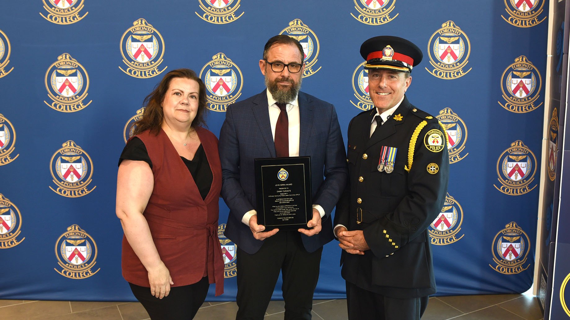 Danny Durante accepts his award alongside his wife Silvia and Superintendent Jack Gurr.