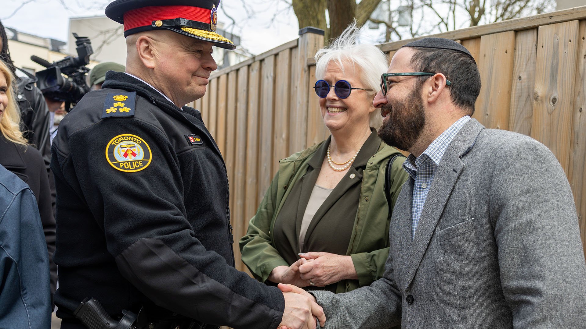 Police officer shaking hands with another person