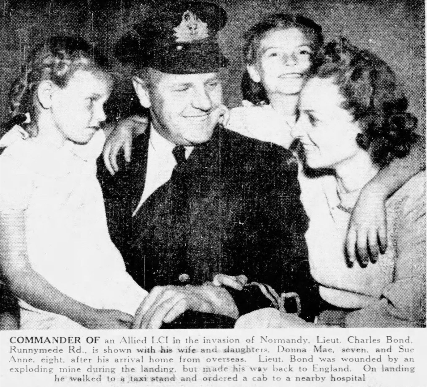Man in miliary uniform with woman and two girls