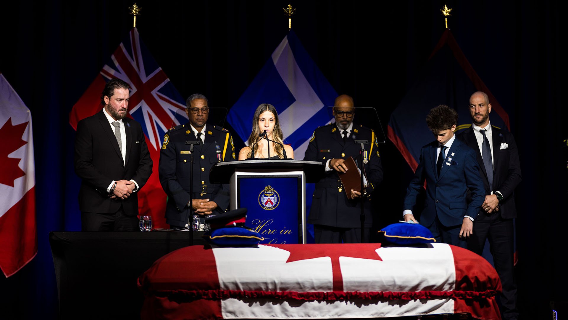 People surround podium in front of casket