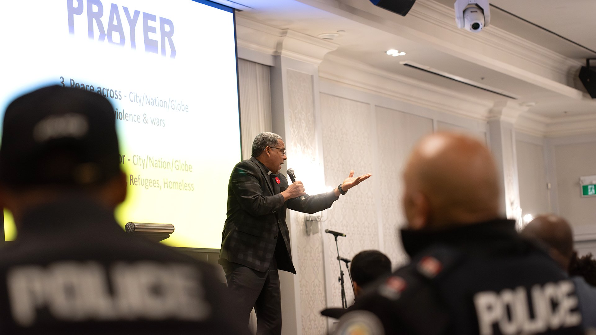 Person on stage in front of police officers
