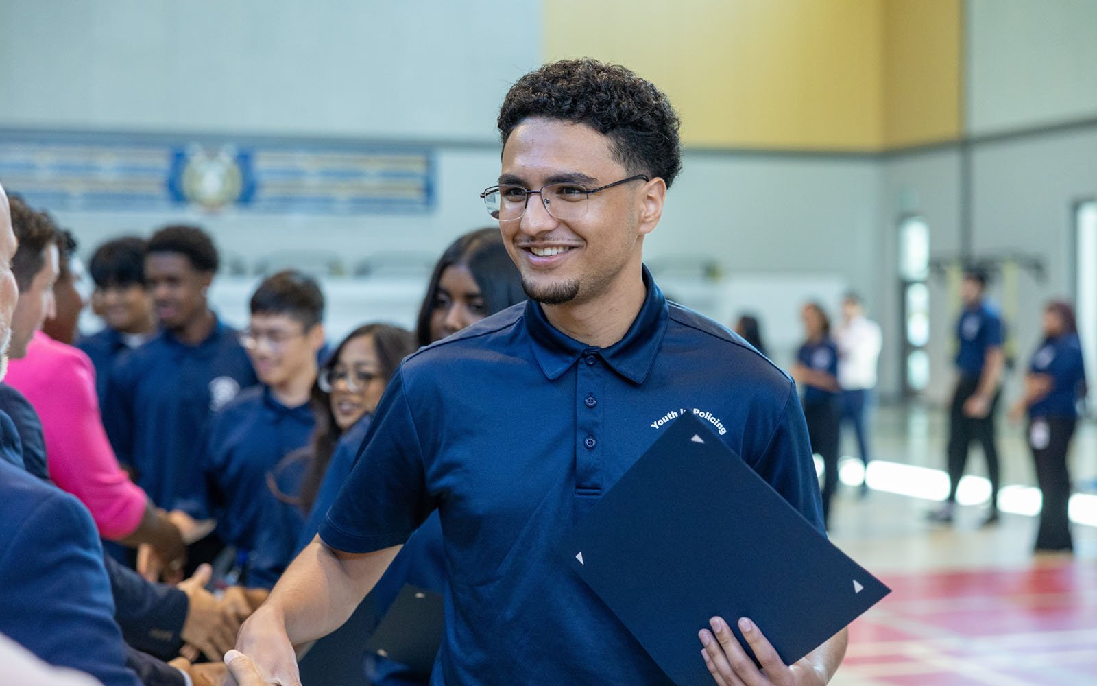 one of the student graduates inside the large hall
